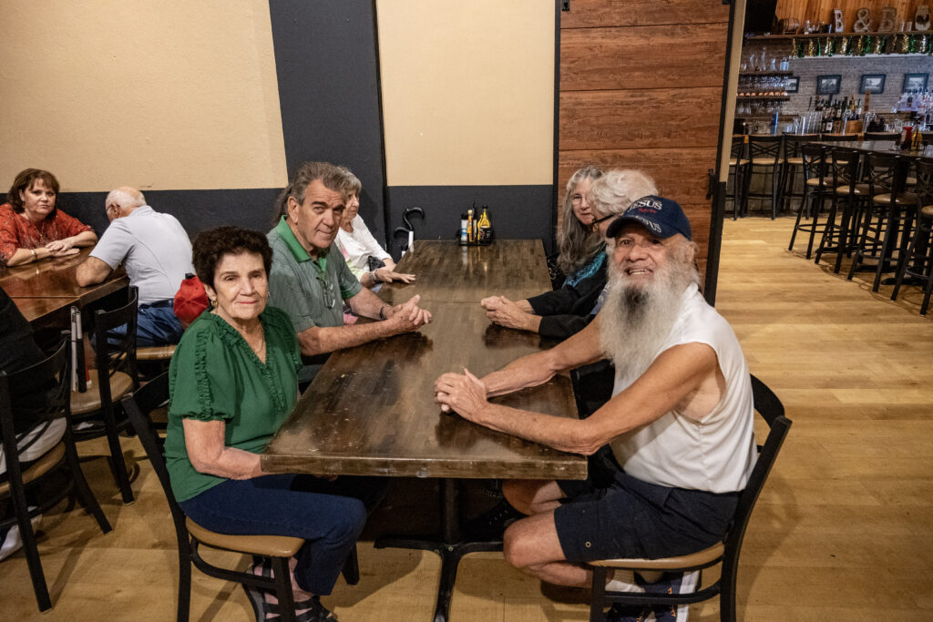 New Vision clients smile for a photo before eating lunch at Brick and Barrell.
