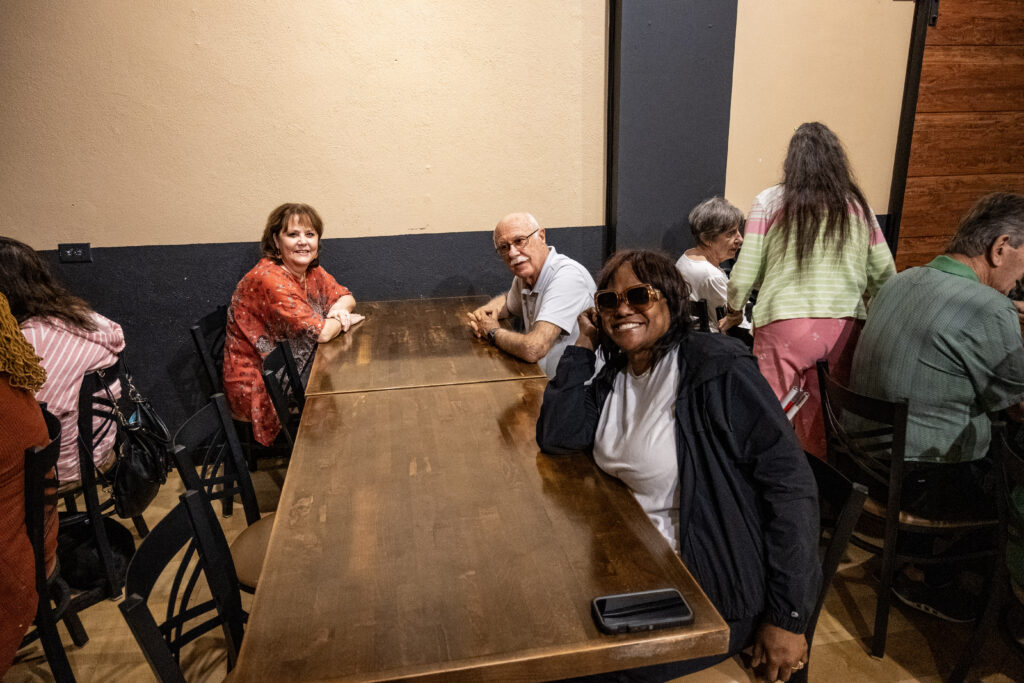 New Vision clients smile for a photo before eating lunch at Brick and Barrell.
