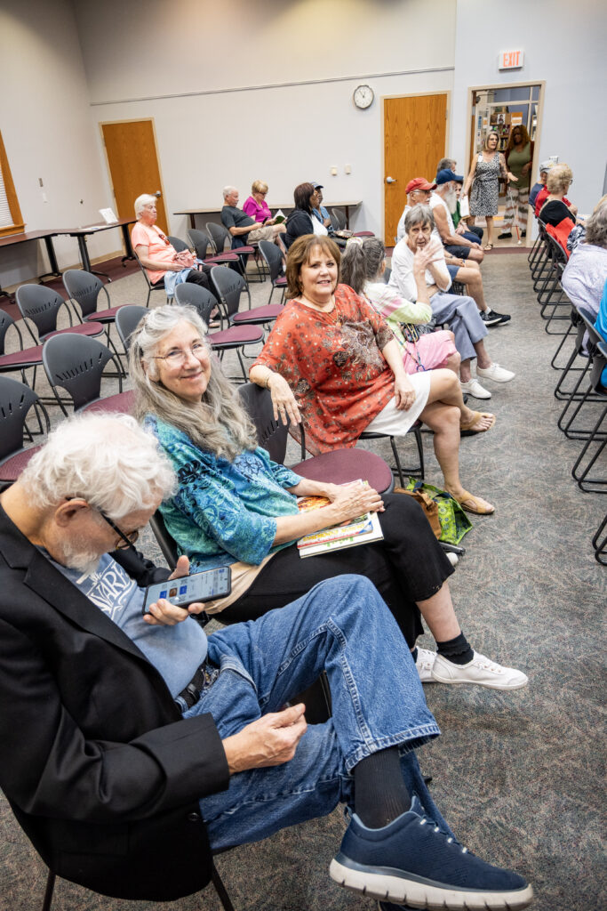 New Vision clients sit in a row of seats, waiting for the music to start at the Leesburg Library.
